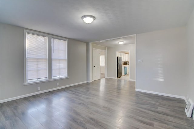 spare room with dark hardwood / wood-style floors