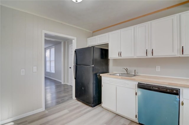 kitchen featuring black refrigerator, white cabinets, dishwasher, and crown molding