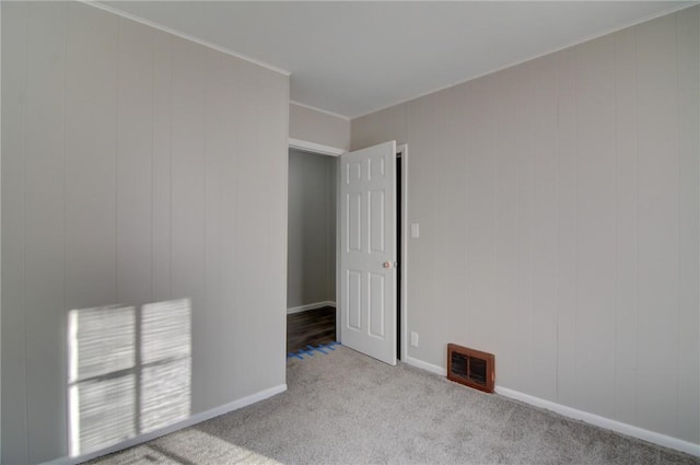 spare room featuring light colored carpet