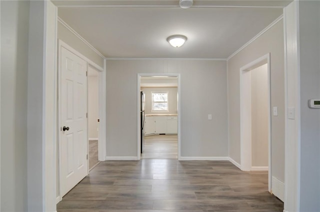 hallway with ornamental molding and hardwood / wood-style flooring