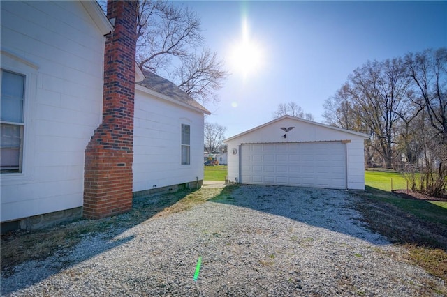 view of side of home featuring a garage and an outdoor structure