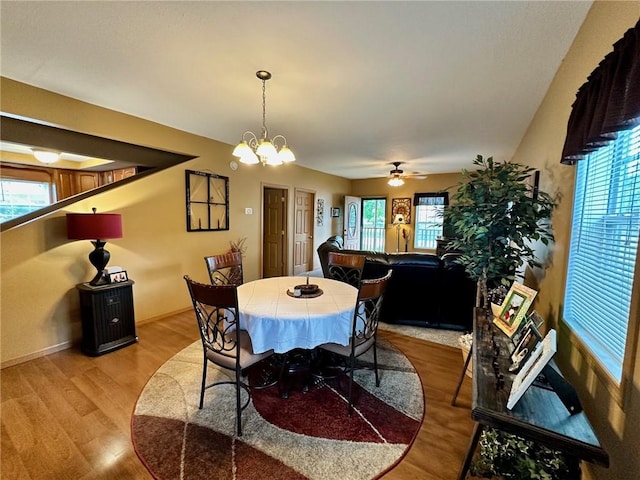 1220 Dewitt Ave, Mattoon, IL 61938 - dining room with light wood-style floors, ceiling fan, and a chandelier