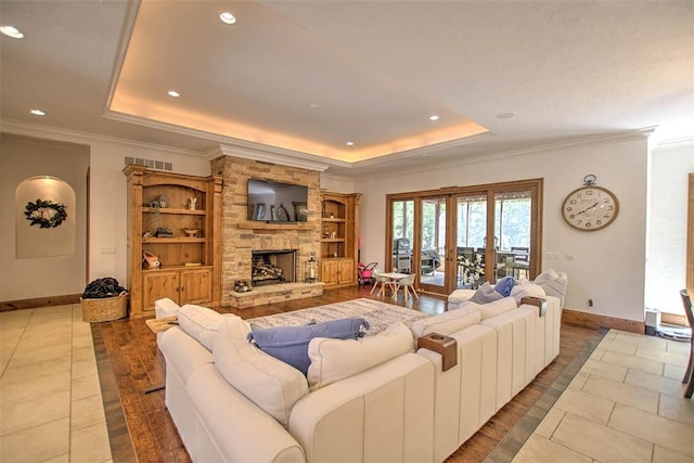 2125 Reserve Way, Decatur, IL 62521 - living room featuring a tray ceiling, baseboards, crown molding, a fireplace, and recessed lighting
