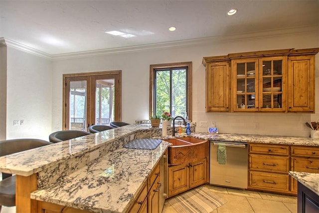 2125 Reserve Way, Decatur, IL 62521 - kitchen featuring dishwasher, brown cabinets, a peninsula, glass insert cabinets, and crown molding