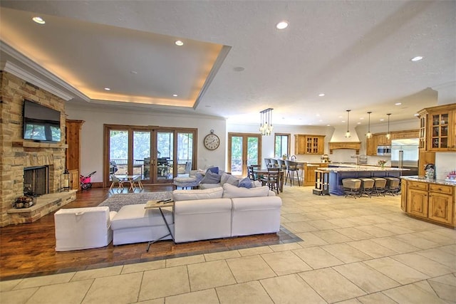 2125 Reserve Way, Decatur, IL 62521 - living area featuring french doors, healthy amount of natural light, recessed lighting, light tile patterned floors, and a fireplace