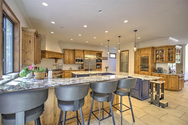 2125 Reserve Way, Decatur, IL 62521 - kitchen featuring high end appliances, a peninsula, custom exhaust hood, a kitchen island, and recessed lighting