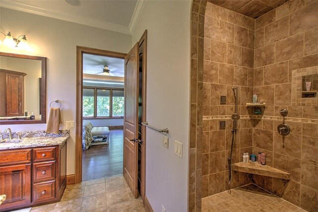 2125 Reserve Way, Decatur, IL 62521 - ensuite bathroom with ornamental molding, a tile shower, vanity, baseboards, and ceiling fan