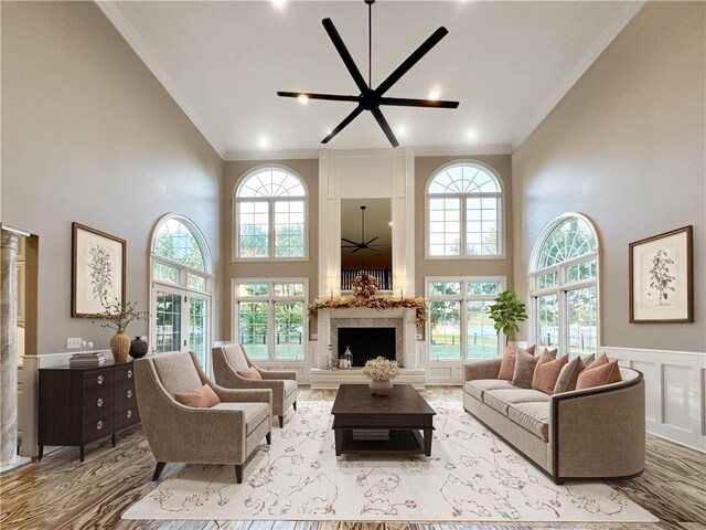 living room featuring a wealth of natural light, ceiling fan, and ornamental molding