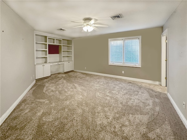 unfurnished living room featuring ceiling fan and light colored carpet