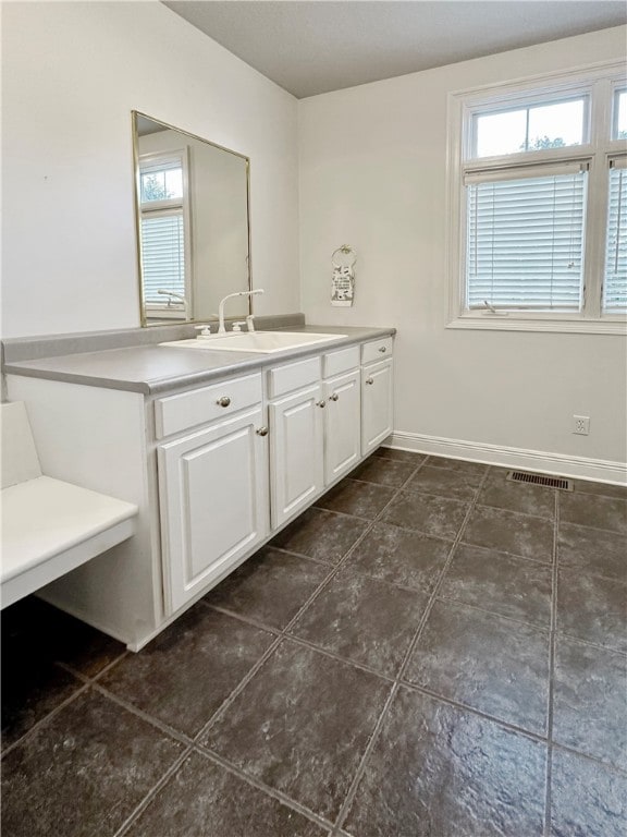 bathroom with tile patterned flooring and vanity