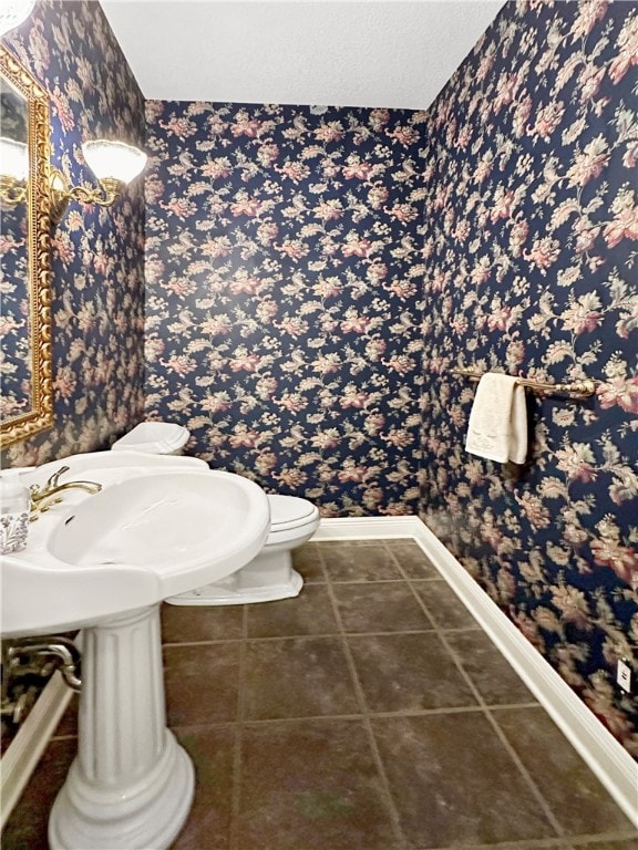 bathroom featuring tile patterned floors and toilet