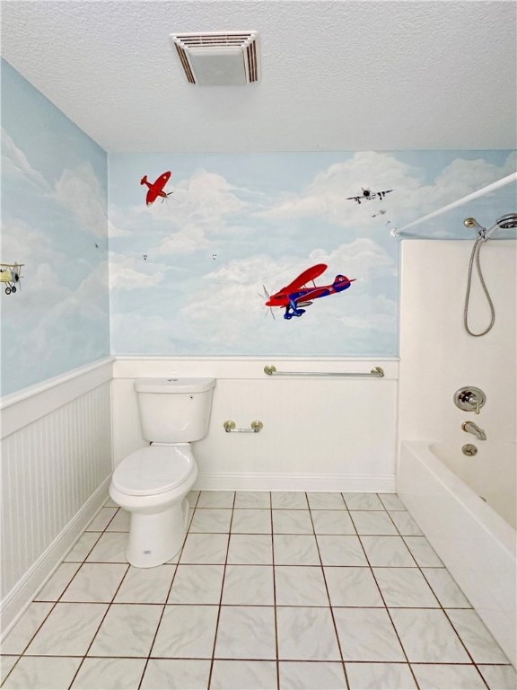 bathroom with shower / tub combination, tile patterned flooring, a textured ceiling, and toilet