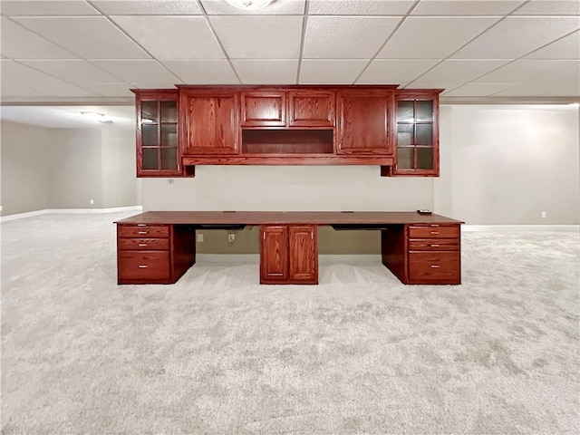 unfurnished office featuring a drop ceiling and light colored carpet