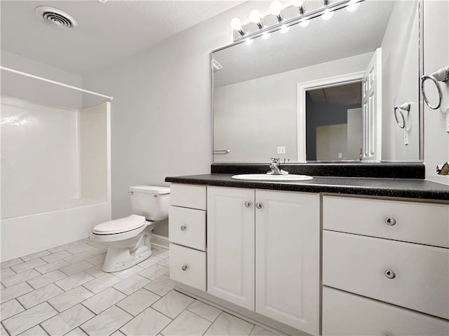 full bathroom with vanity, toilet, a textured ceiling, and bathtub / shower combination