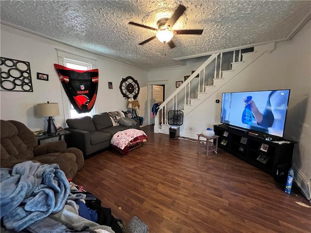 living room with crown molding, wood finished floors, stairway, a textured ceiling, and a ceiling fan