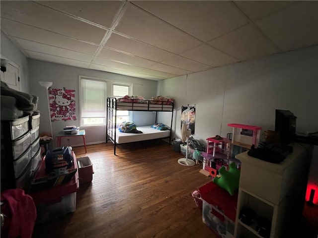 bedroom featuring a paneled ceiling and wood finished floors