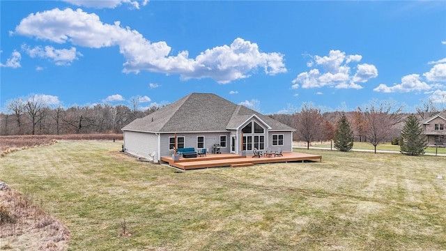 back of property featuring a wooden deck and a yard