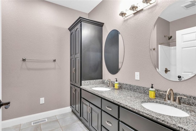 bathroom featuring tile patterned flooring and vanity