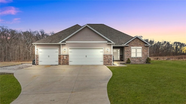 craftsman house with a garage and a lawn