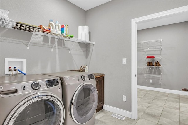 clothes washing area with cabinets and independent washer and dryer