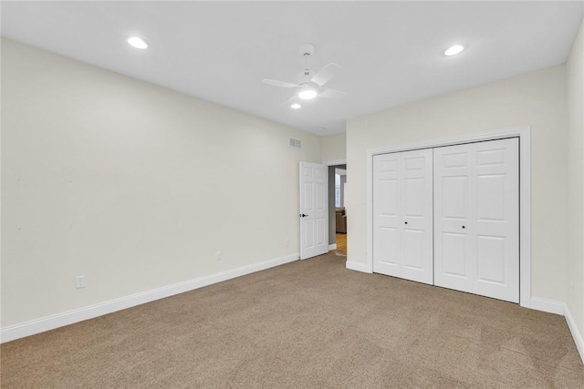 unfurnished bedroom featuring carpet flooring, ceiling fan, and a closet