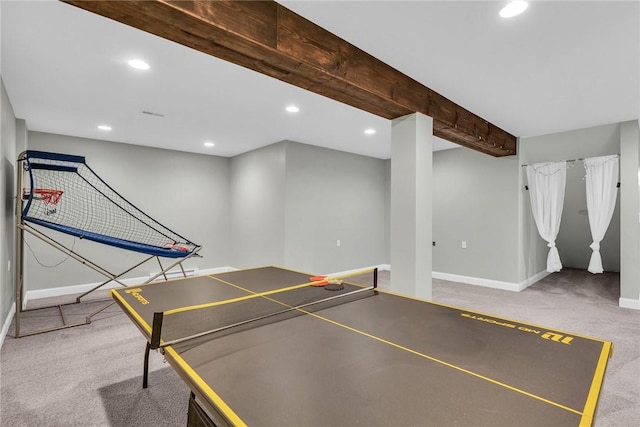 recreation room featuring beam ceiling and carpet