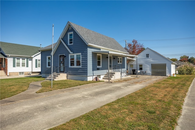 bungalow with a porch, a garage, an outdoor structure, and a front yard