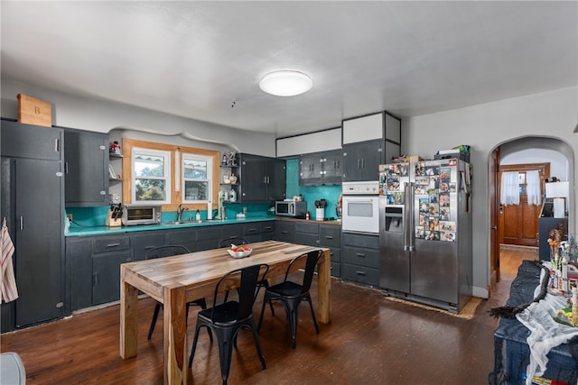 kitchen featuring tasteful backsplash, sink, dark hardwood / wood-style flooring, and appliances with stainless steel finishes