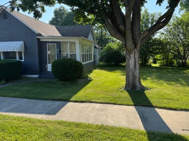 414 S Worth St, Sullivan, IL 61951 - view of home's exterior with a yard and a shingled roof