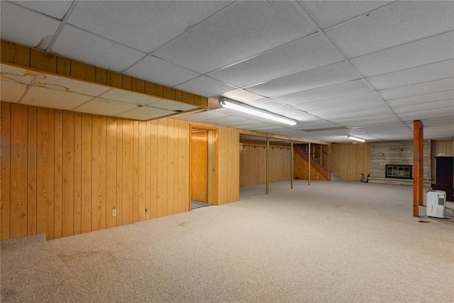 300 Olive St, Watson, IL 62473 - finished basement featuring a drop ceiling, carpet floors, a large fireplace, and wooden walls