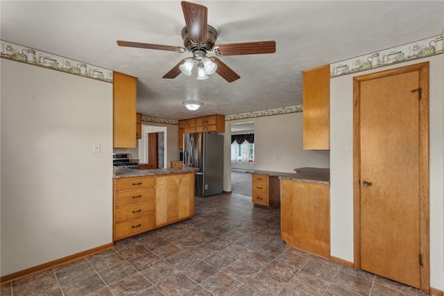 300 Olive St, Watson, IL 62473 - kitchen with stainless steel appliances, a ceiling fan, stone finish flooring, brown cabinets, and dark countertops