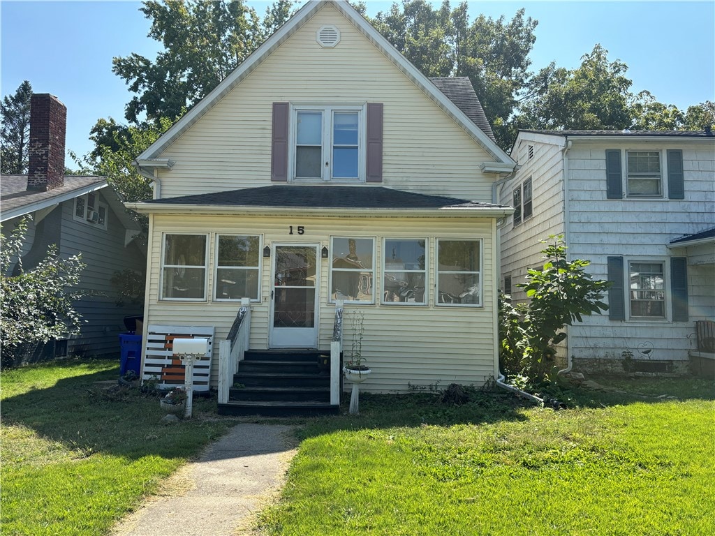 bungalow-style house featuring a front yard