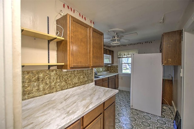 1591 Decatur St, Decatur, IL 62522 - kitchen with white appliances, open shelves, a ceiling fan, tasteful backsplash, and brown cabinetry