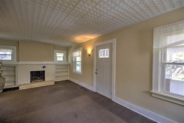 1591 Decatur St, Decatur, IL 62522 - entrance foyer featuring dark colored carpet and a fireplace