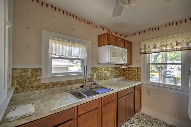 1591 Decatur St, Decatur, IL 62522 - kitchen featuring white microwave, brown cabinetry, and light countertops