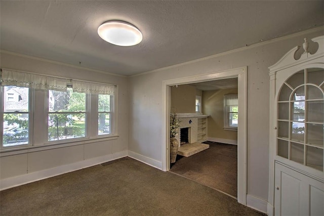 1591 Decatur St, Decatur, IL 62522 - unfurnished living room with dark carpet, ornamental molding, a brick fireplace, and a textured ceiling