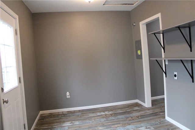 empty room featuring baseboards and wood finished floors