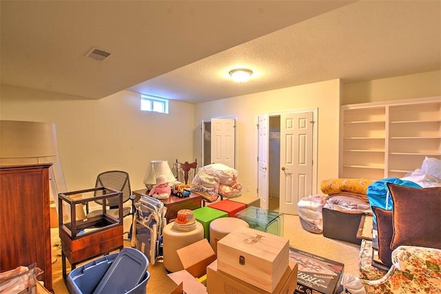 playroom featuring visible vents and a textured ceiling