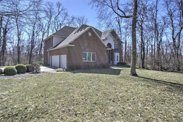 view of side of property with concrete driveway, an attached garage, a lawn, and brick siding