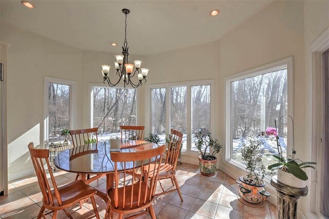 tiled dining room featuring recessed lighting and an inviting chandelier