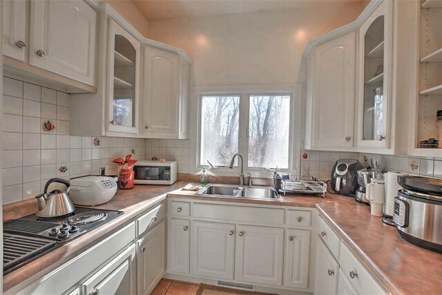 kitchen featuring a kitchen island, dishwasher, light tile patterned floors, recessed lighting, and a fireplace