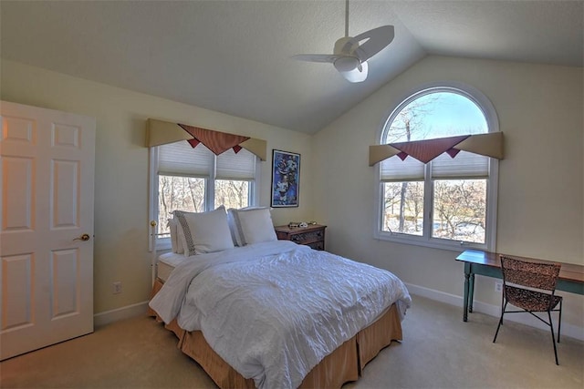 bedroom with vaulted ceiling, light colored carpet, and baseboards