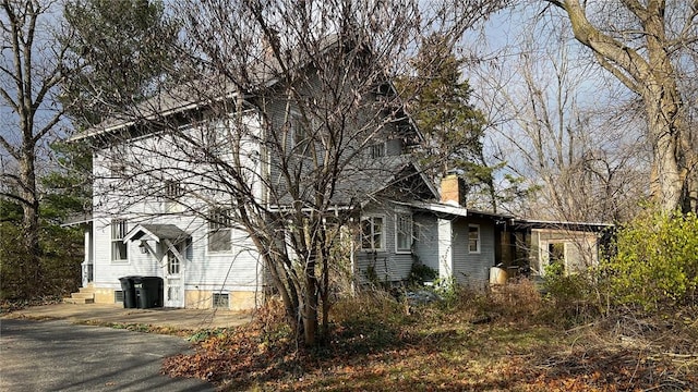 view of property exterior featuring a chimney