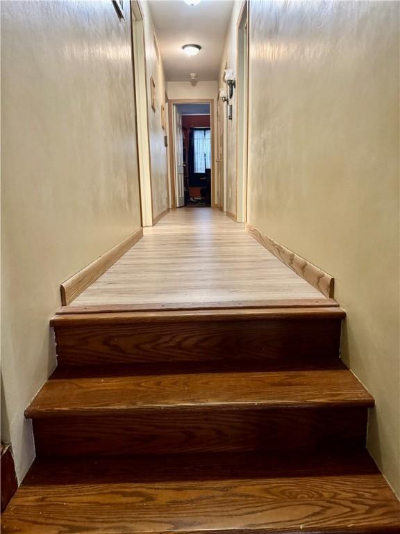 stairway featuring wood finished floors
