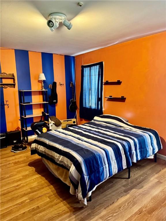 bedroom with wood finished floors