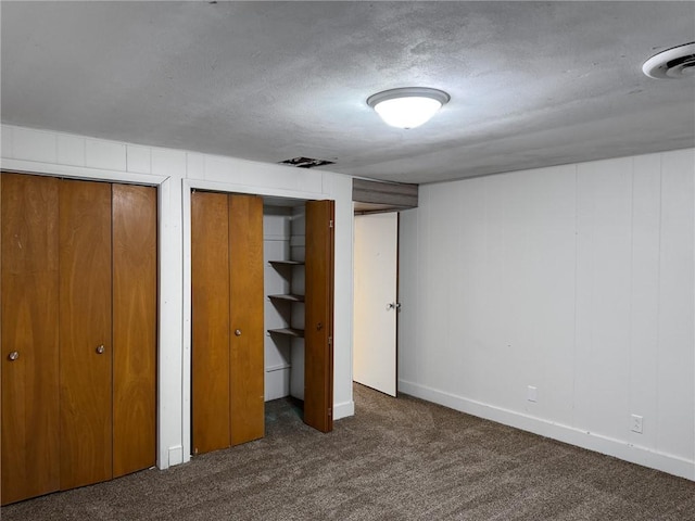 1511 E Fayette Ave, Teutopolis, IL 62467 - unfurnished bedroom with carpet, multiple closets, and a textured ceiling