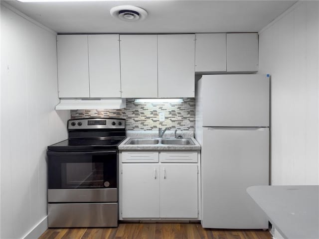 1511 E Fayette Ave, Teutopolis, IL 62467 - kitchen featuring freestanding refrigerator, stainless steel electric range, under cabinet range hood, white cabinets, and backsplash
