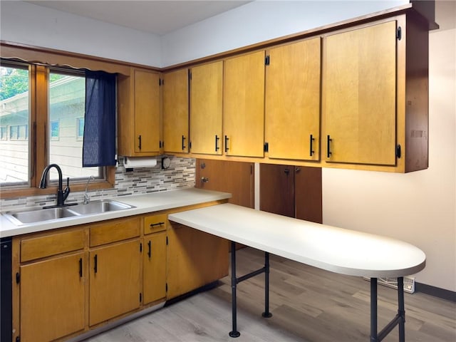 1511 E Fayette Ave, Teutopolis, IL 62467 - kitchen featuring light wood finished floors, decorative backsplash, and light countertops