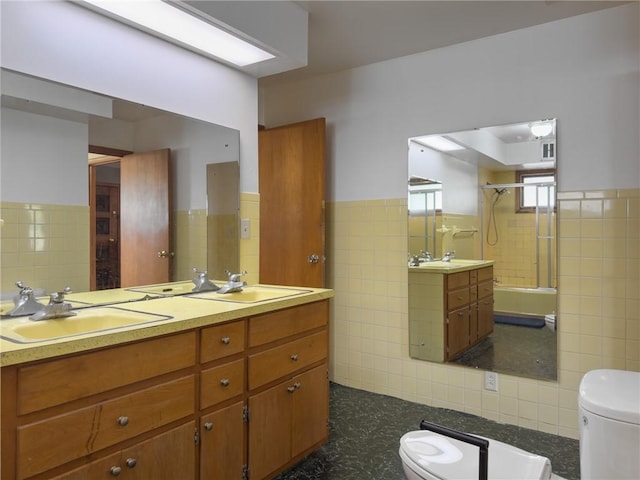 1511 E Fayette Ave, Teutopolis, IL 62467 - bathroom featuring tile walls, a shower with door, double vanity, and wainscoting