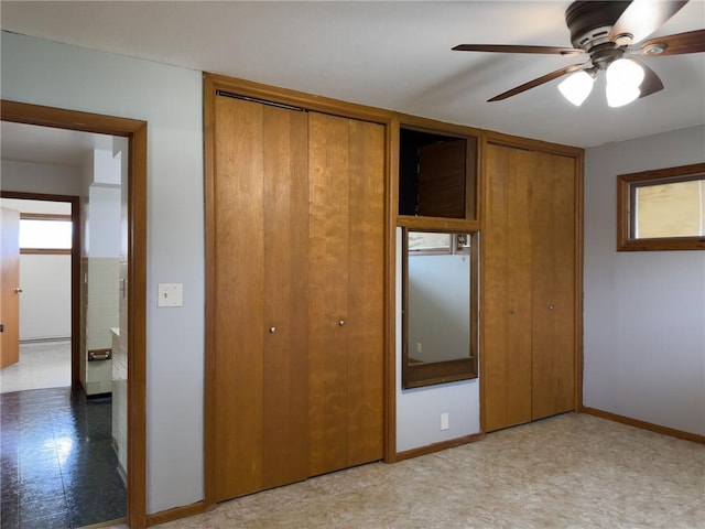 1511 E Fayette Ave, Teutopolis, IL 62467 - unfurnished bedroom with multiple closets, light floors, and a ceiling fan